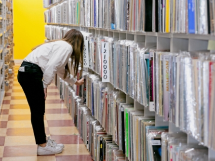 Staff member picking records from a shelf